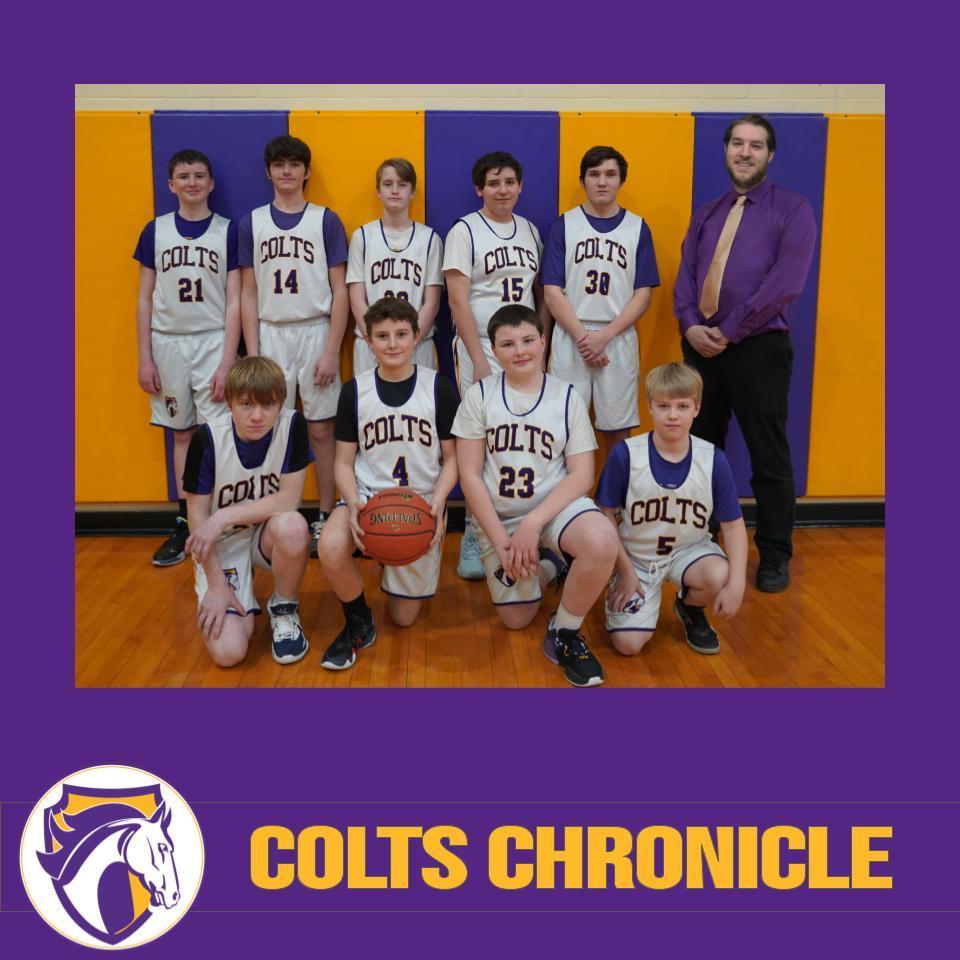 9 boys in white jerseys that say "Colts" with their coach. One boy is holding a basketball.