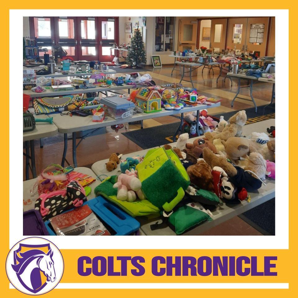 Tables filled with gently used items and toys for the Annual holiday Store fill the gym lobby. 